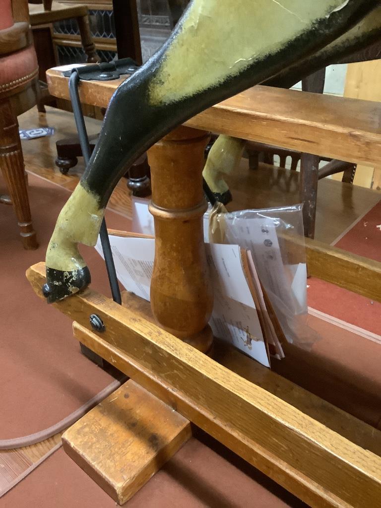 A 1920's F.H. Ayres painted wood rocking horse, on a trestle stand, fully restored in 2009 by Stevenson Bros., length 112cm height 100cm